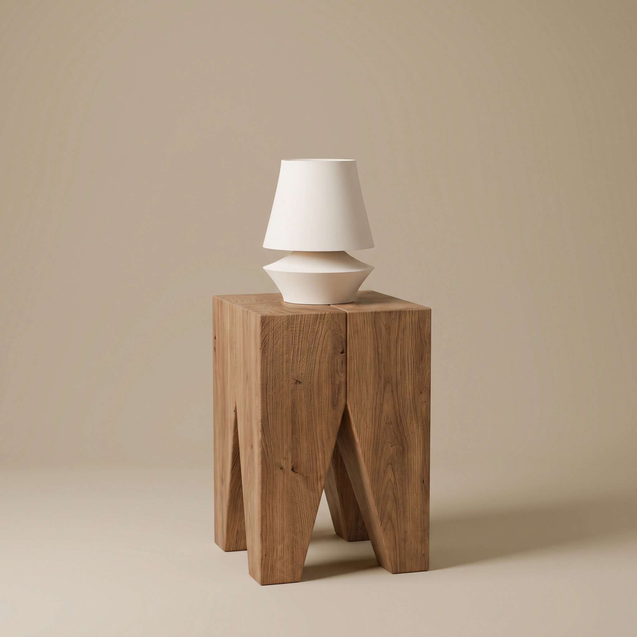 Staccato table lamp in matte Cream on a natural wood side table, wide studio view.