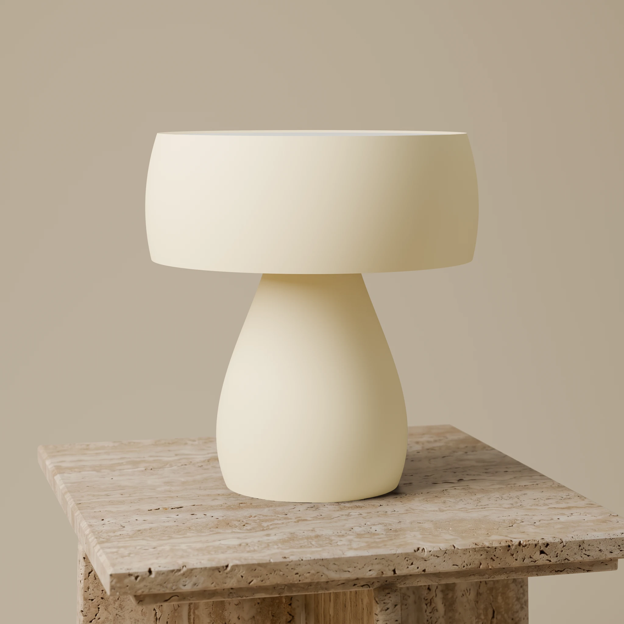 Sway table lamp in matte Butter on a textured beige stone side table, hero studio view.