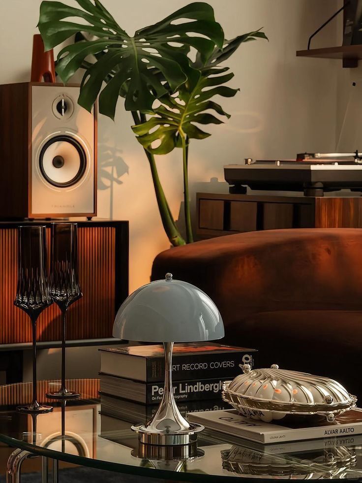 Roma Table Lamp beside a sculptural lounge chair.